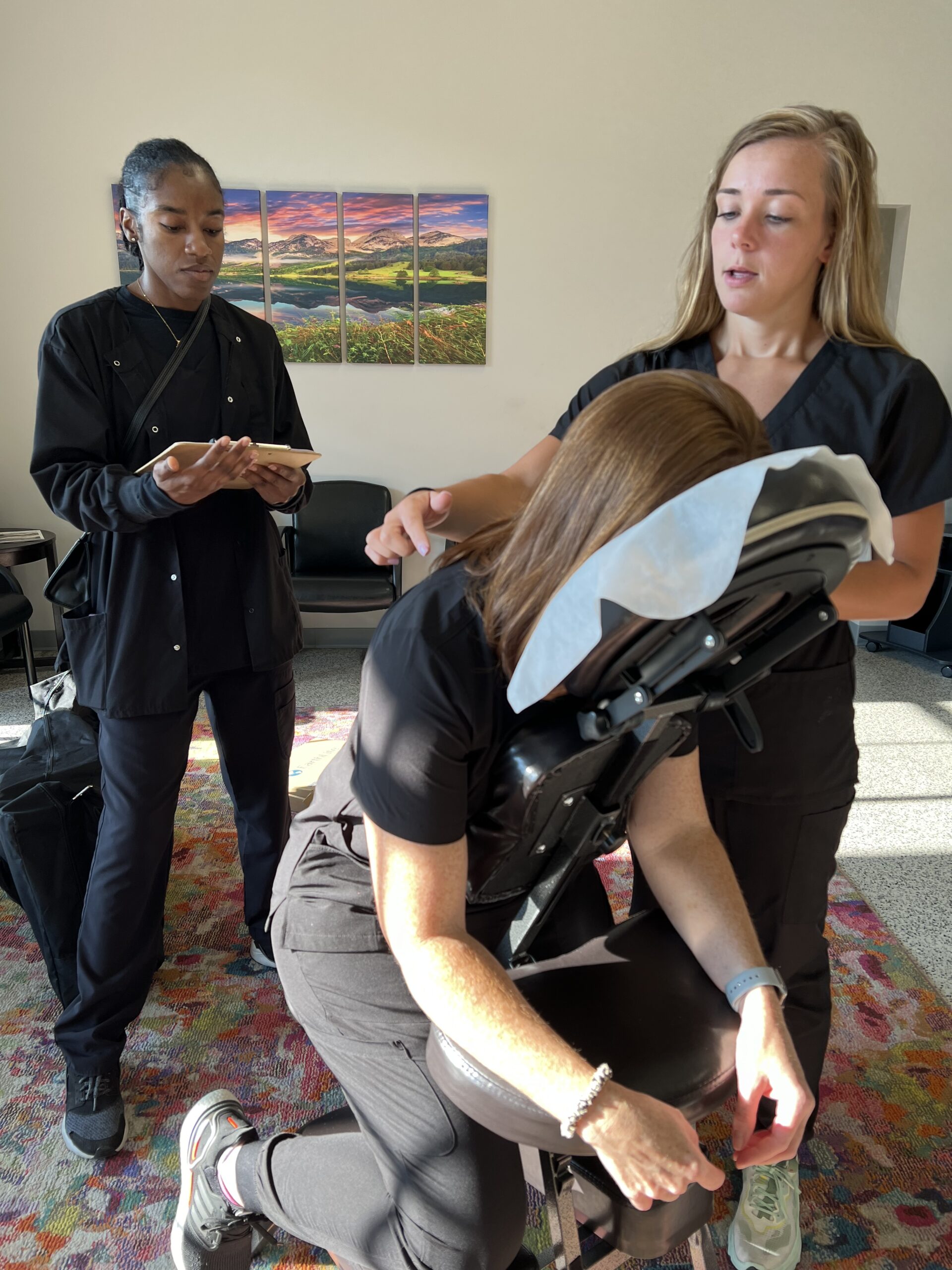 Chiropractor adjusting patient’s posture in therapy chair